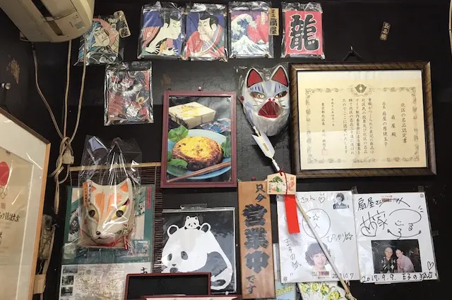 小屋の奥にはキツネのお面や落語家さんのサインなどが貼られていた|厚焼き玉子 扇屋(王子)