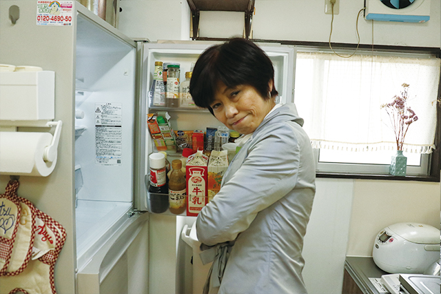 冷蔵庫の前で腕組みする本多先生