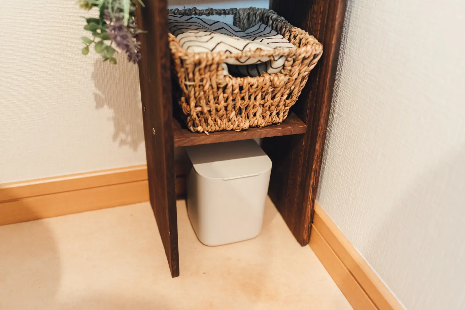 100均の材料で作るトイレ収納の中段には生理用品を収納できる籠を設置し、下段にはゴミ箱を置いた様子